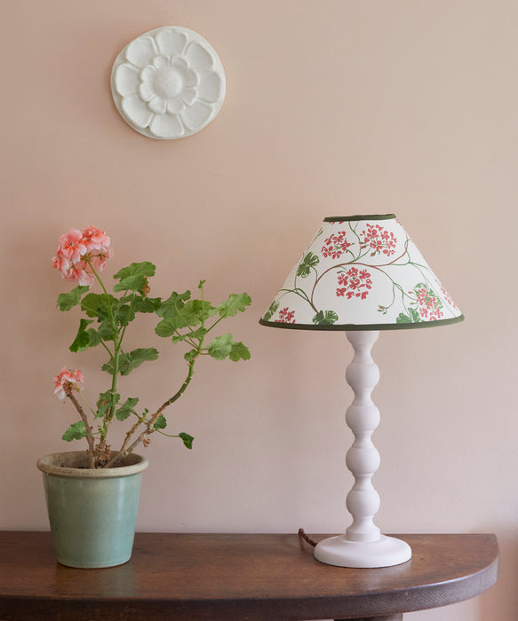 Geraniums, paper lampshade, conical